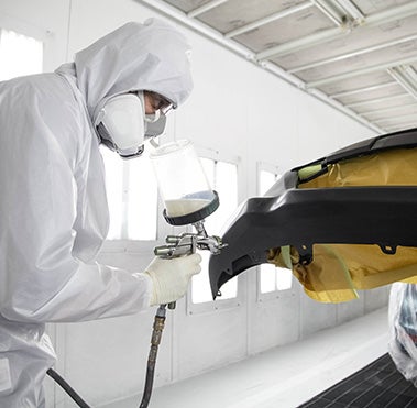 Collision Center Technician Painting a Vehicle | Vann York Toyota in High Point NC