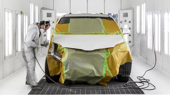 Collision Center Technician Painting a Vehicle | Vann York Toyota in High Point NC